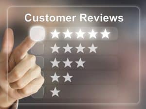 A hand selects five stars on a digital interface for gathering customer reviews.